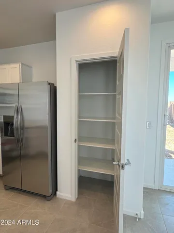 a kitchen with a refrigerator and a sink