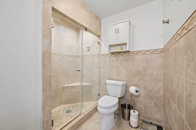a bathroom with a toilet and a shower