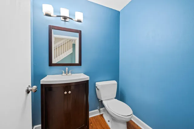 a bathroom with a toilet a sink and mirror