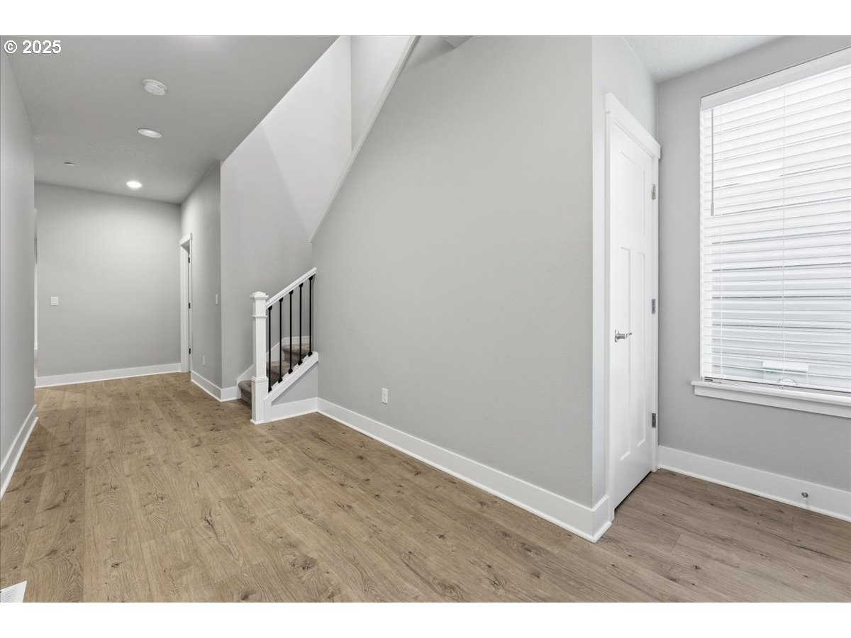 8565 Southwest 176th Avenue Beaverton, OR 97007 - Photo 2 of 39 a view of an empty room with wooden floor and a window