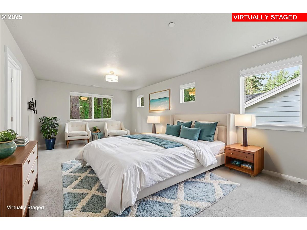 8565 Southwest 176th Avenue Beaverton, OR 97007 - Photo 21 of 39 a spacious bedroom with a bed a table and chair