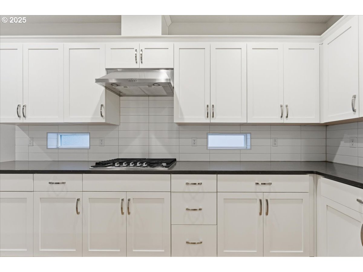 8565 Southwest 176th Avenue Beaverton, OR 97007 - Photo 7 of 39 a kitchen with granite countertop white cabinets and a stove