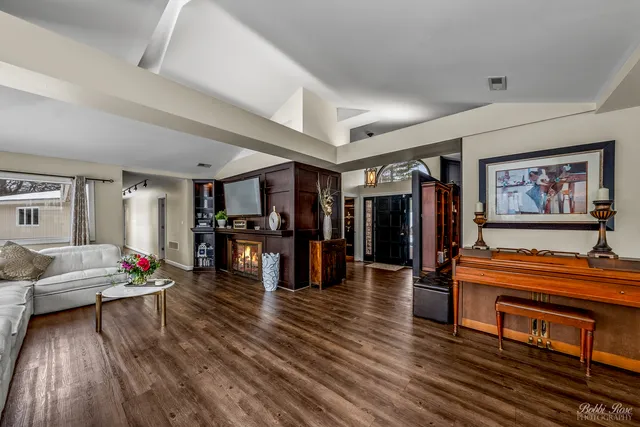 a dining room with furniture and wooden floor