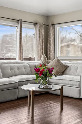 a spacious bathroom with a granite countertop sink a toilet a mirror and shower