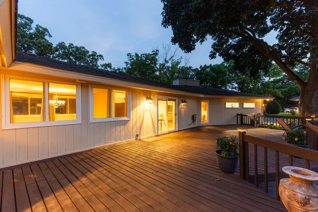 a view of a deck with wooden floor and outdoor seating