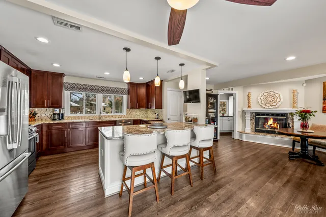 a large kitchen with kitchen island granite countertop a large island in the center and stainless steel appliances