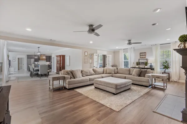 a living room with furniture and view of kitchen