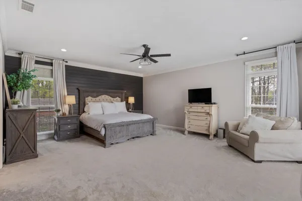 a spacious bedroom with a bed and a couch