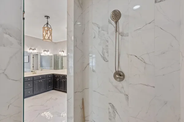 a bathroom with a mirror and a shower