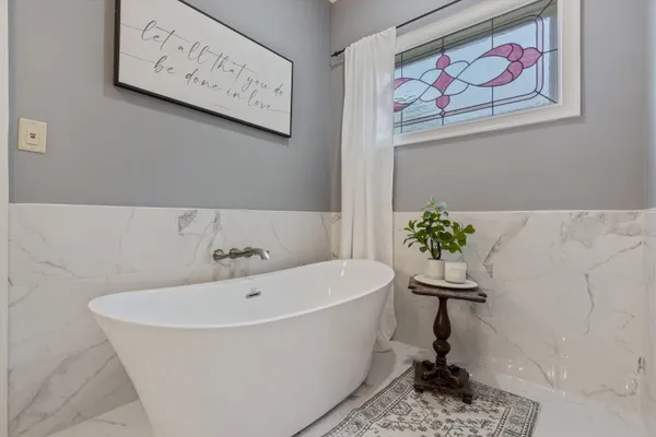 a white bath tub sitting in a bathroom