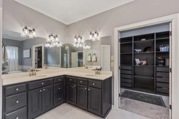 a spacious bathroom with a double vanity sink and a mirror