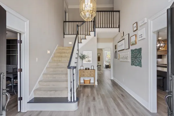a view of entryway and hall with wooden floor