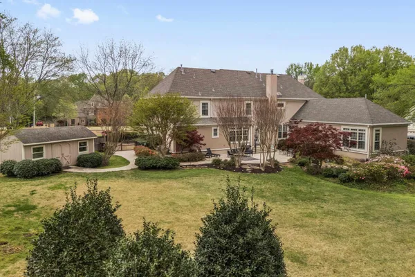 a view of a house with a yard and sitting area