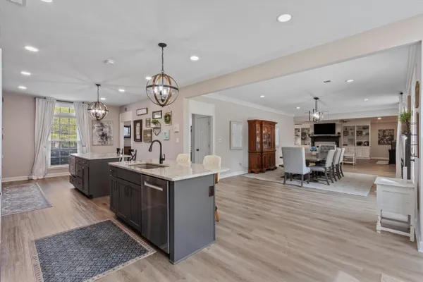 a kitchen with stainless steel appliances granite countertop a stove and a wooden floors