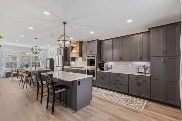 a kitchen with granite countertop cabinets a dining table and chairs