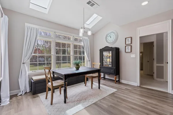a view of a work space with furniture window and wooden floor