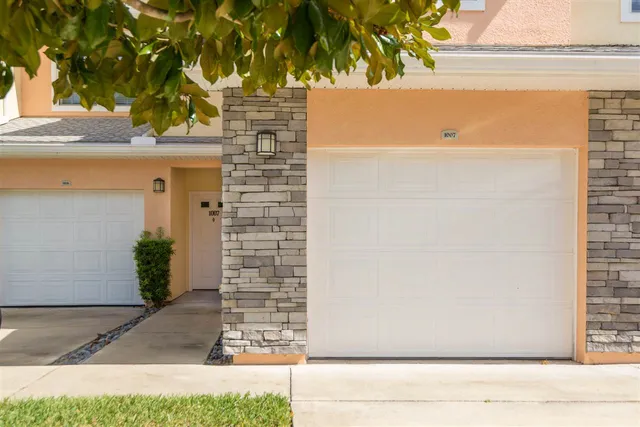 a view of house with a tree