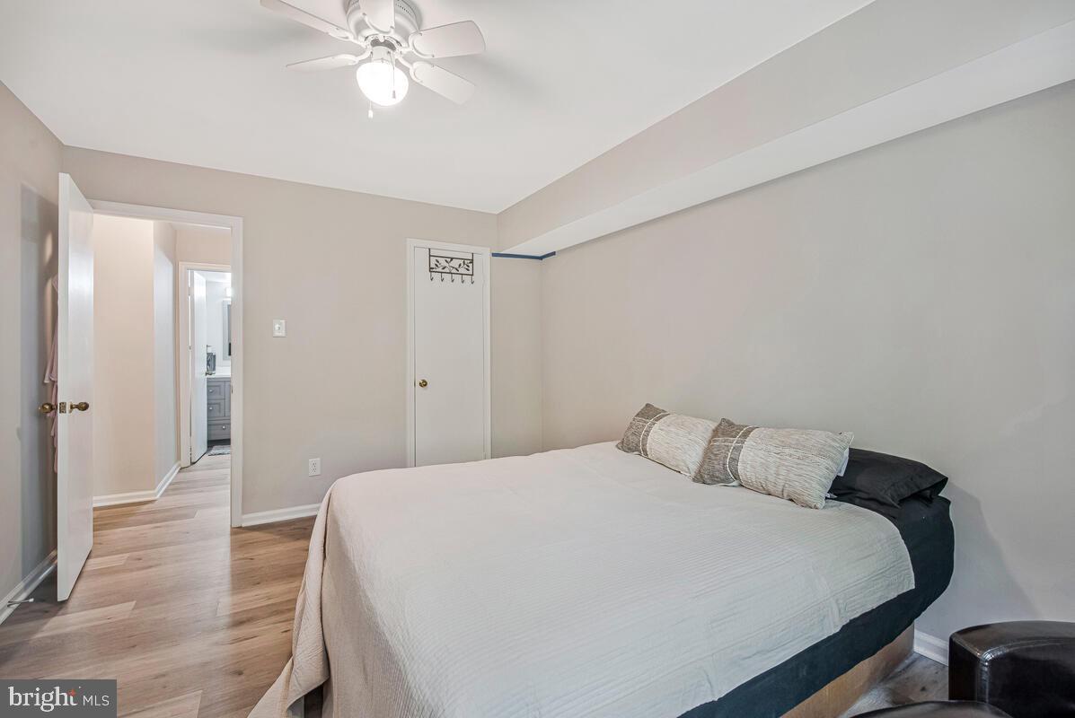 20334 Beaconfield Terrace, Unit 2 Germantown, MD 20874 - Photo 14 of 24 a bedroom with a bed and a chandelier