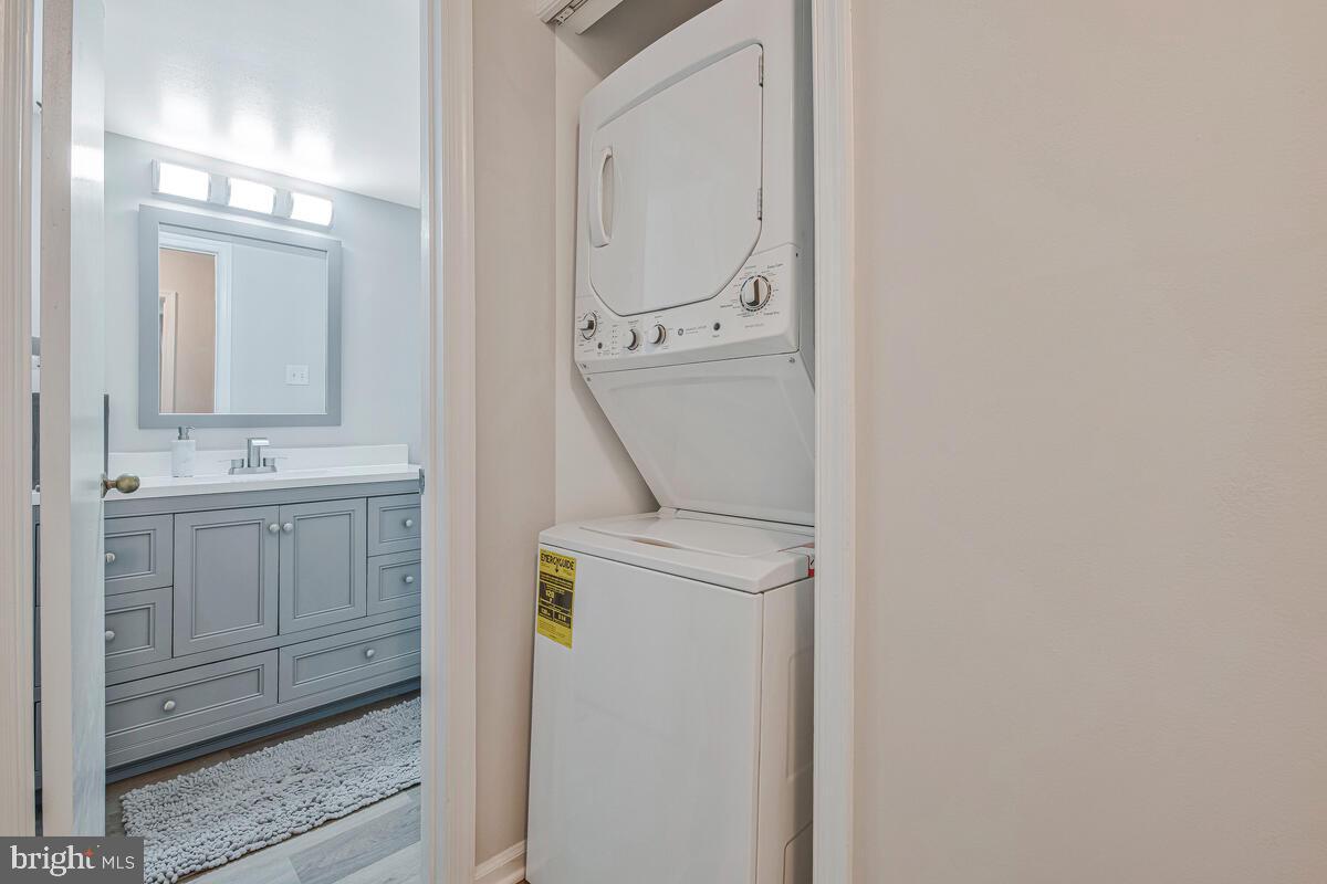 20334 Beaconfield Terrace, Unit 2 Germantown, MD 20874 - Photo 15 of 24 a bathroom with a granite countertop sink and a mirror