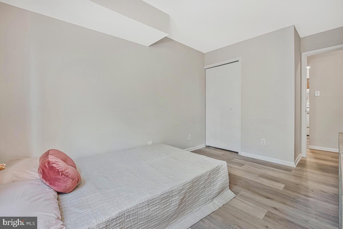 20334 Beaconfield Terrace, Unit 2 Germantown, MD 20874 - Photo 19 of 24 a bedroom with a bed and a chandelier