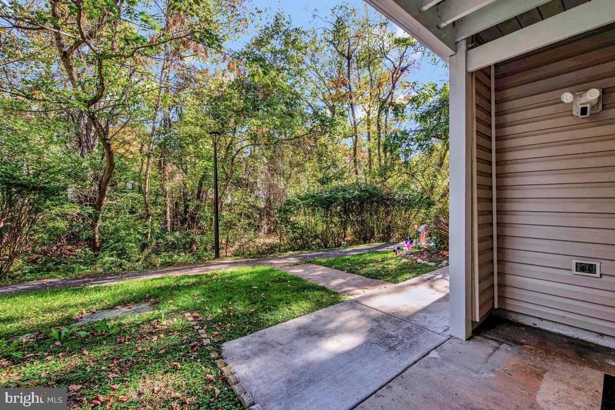 20334 Beaconfield Terrace, Unit 2 Germantown, MD 20874 - Photo 22 of 24 a view of a back yard from a brick wall