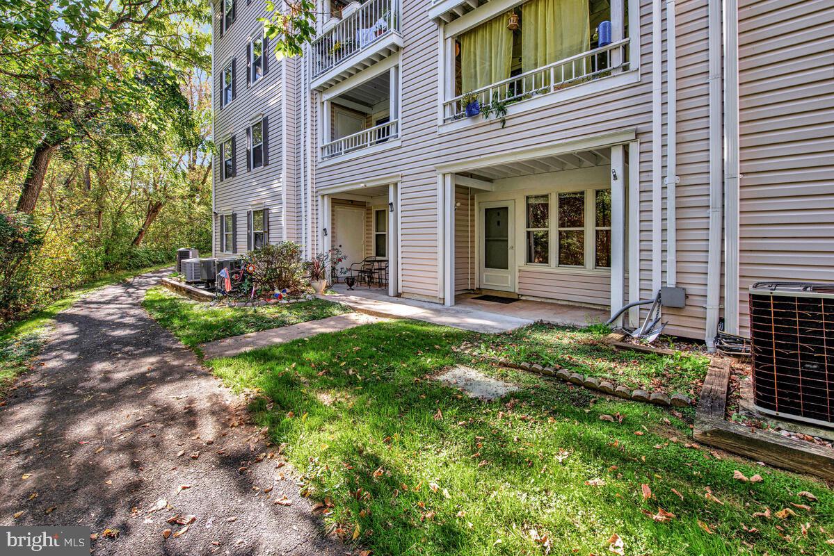 20334 Beaconfield Terrace, Unit 2 Germantown, MD 20874 - Photo 24 of 24 a front view of a house with garden