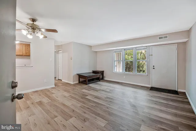 wooden floor in an empty room with a window