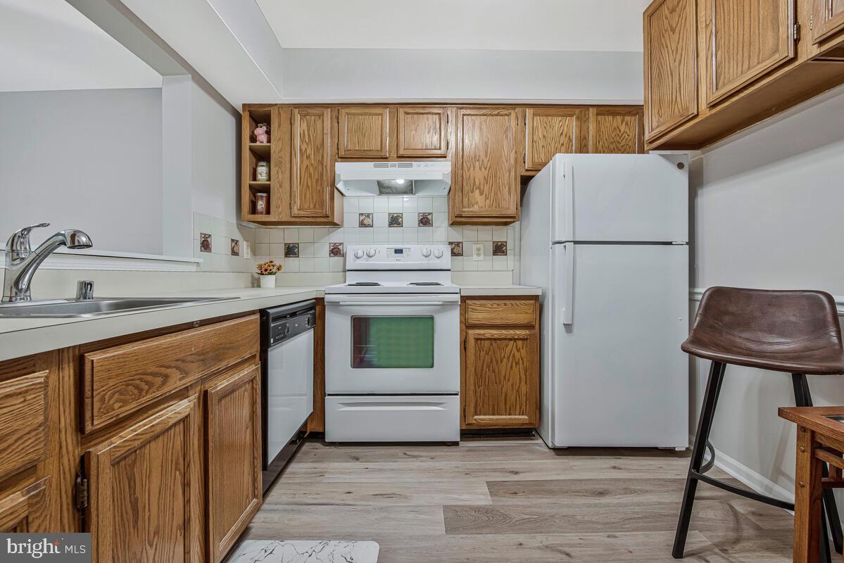 20334 Beaconfield Terrace, Unit 2 Germantown, MD 20874 - Photo 9 of 24 a kitchen with a refrigerator sink and stove
