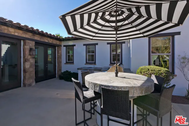 a view of a chairs and table in backyard