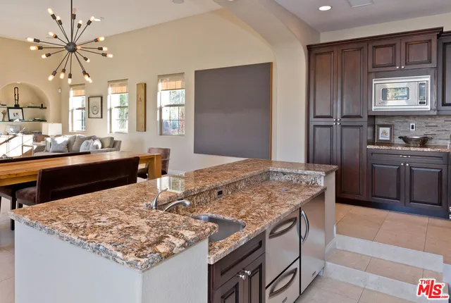 a stove top oven sitting inside of a kitchen