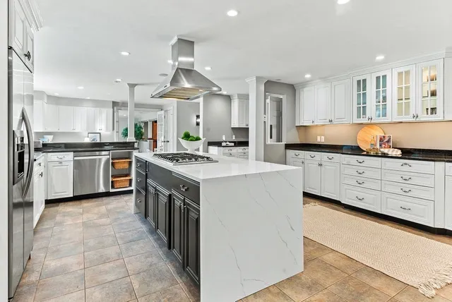 a kitchen with stainless steel appliances a sink stove and cabinets