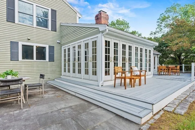 a backyard of a house with barbeque oven table and chairs