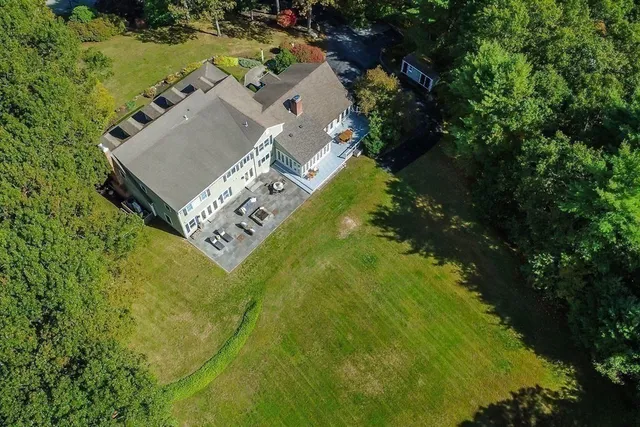 an aerial view of a house with a yard