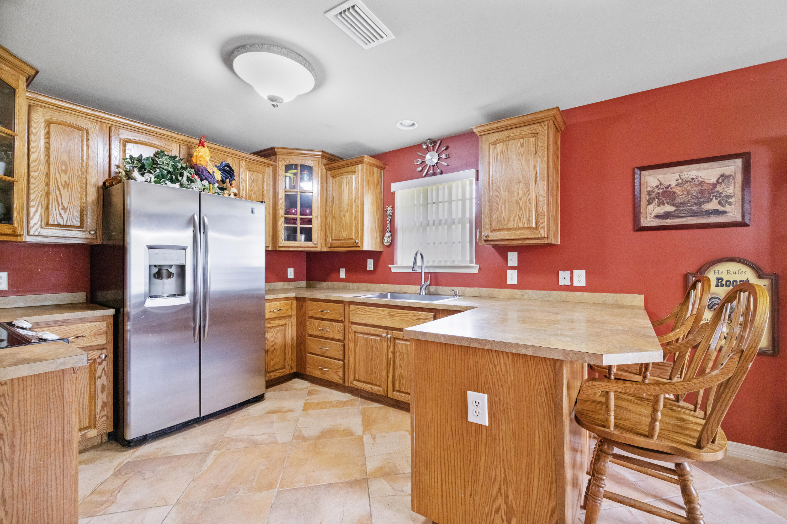 1582 Greenwood Road Baker, FL 32531 - Photo 12 of 52 a kitchen with stainless steel appliances granite countertop a refrigerator a sink dishwasher a dining table and chairs with wooden floor