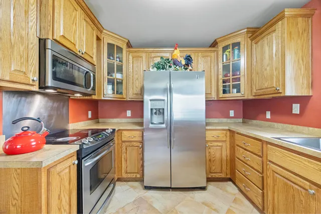 a kitchen with stainless steel appliances granite countertop a refrigerator stove and microwave