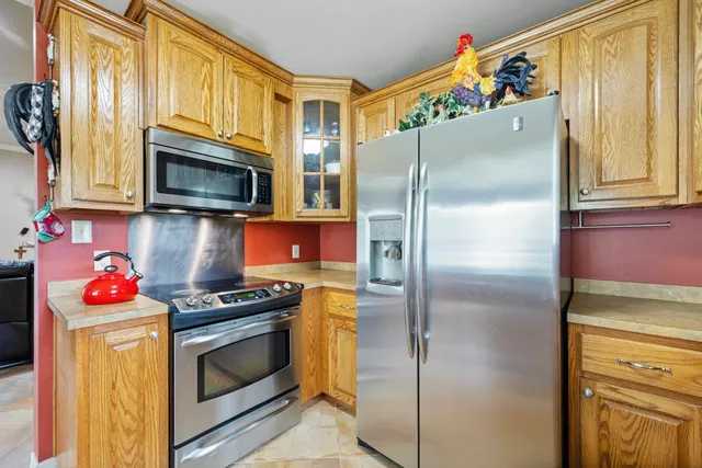 a kitchen with stainless steel appliances granite countertop a sink and cabinets
