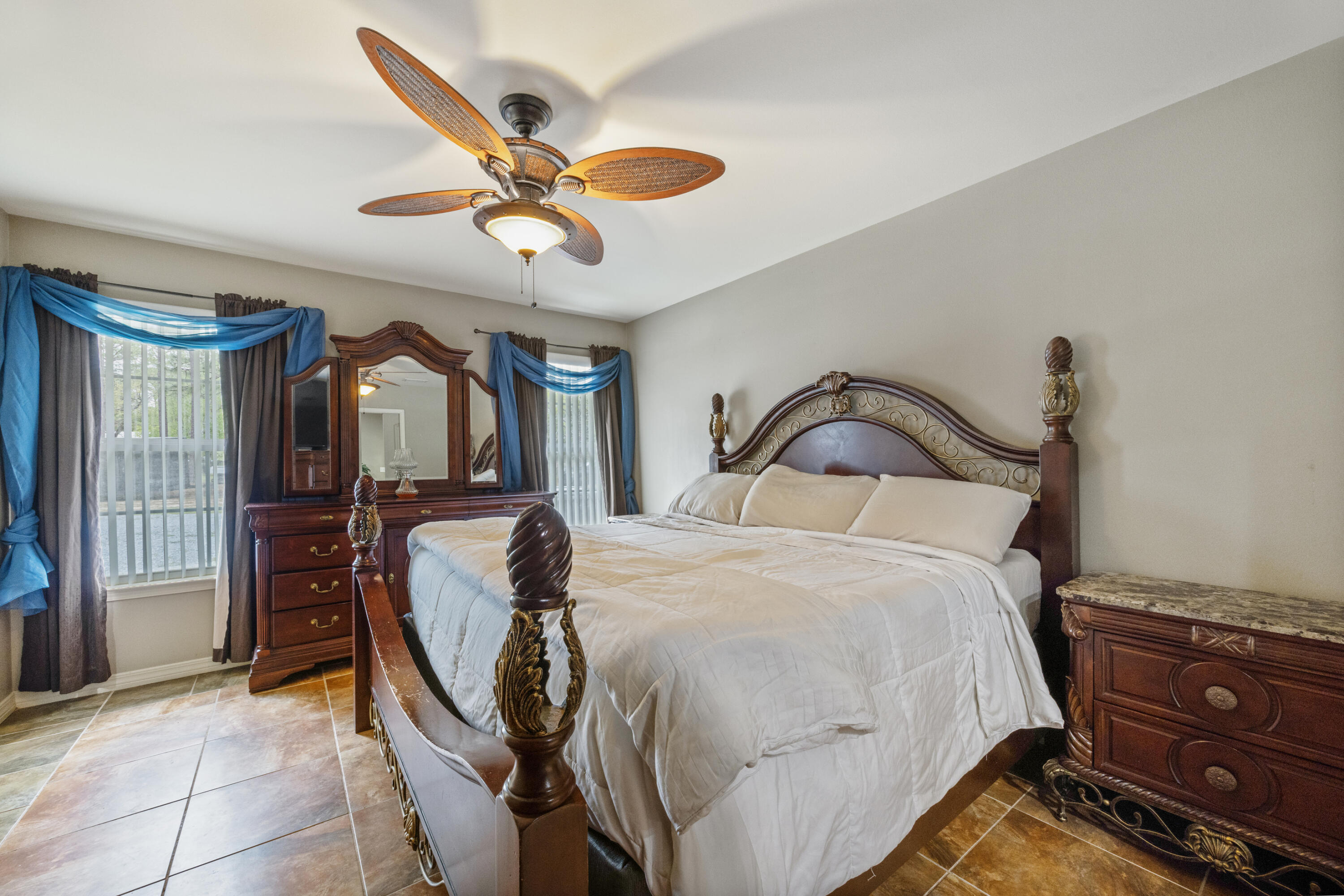 1582 Greenwood Road Baker, FL 32531 - Photo 17 of 52 a bedroom with a bed and a ceiling fan