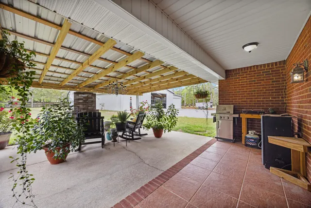 a view of a patio with table and chairs and potted plants