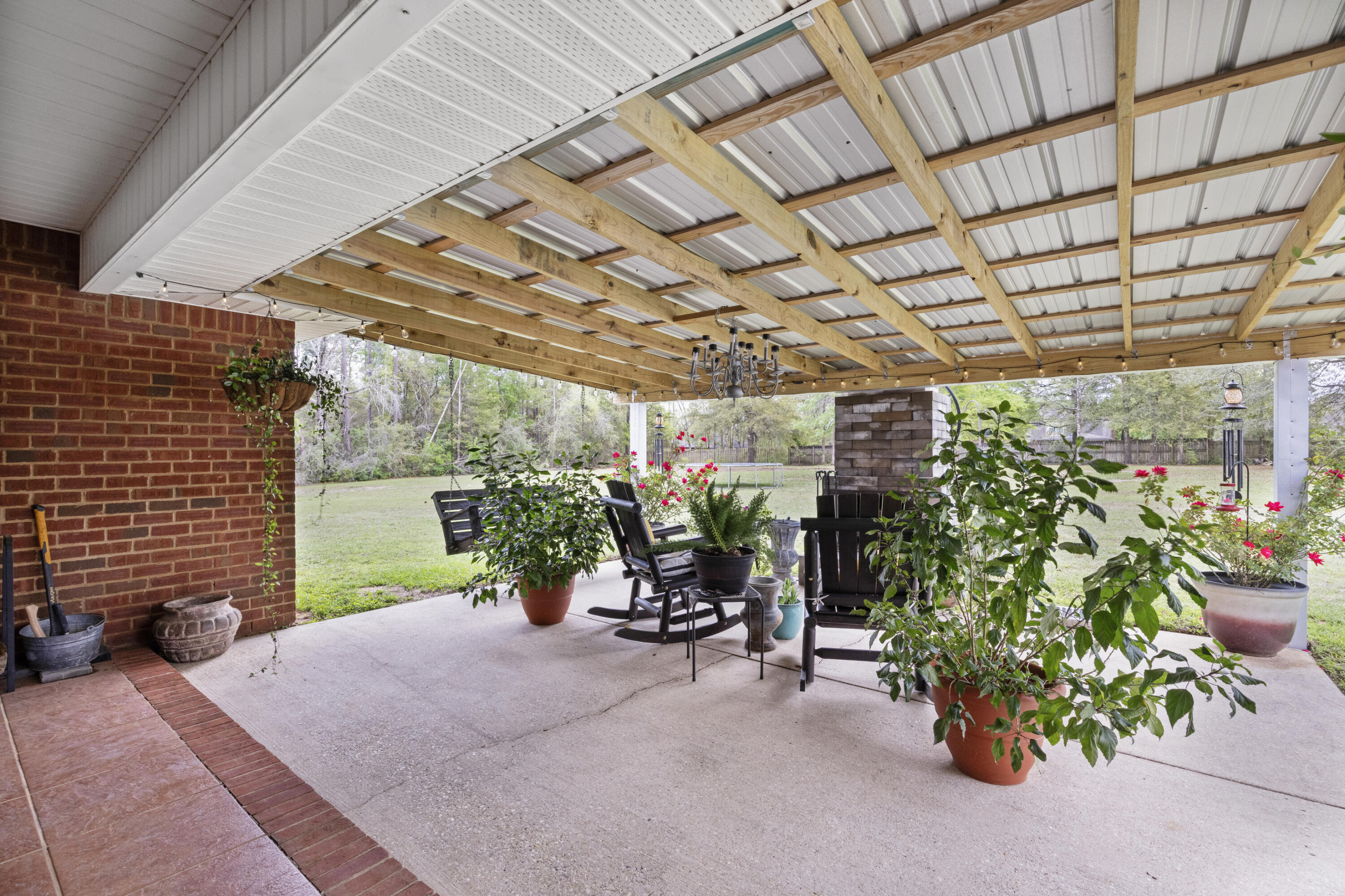 1582 Greenwood Road Baker, FL 32531 - Photo 27 of 52 a view of a patio with table and chairs and potted plants