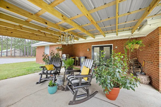 a view of a house with a patio and a garden