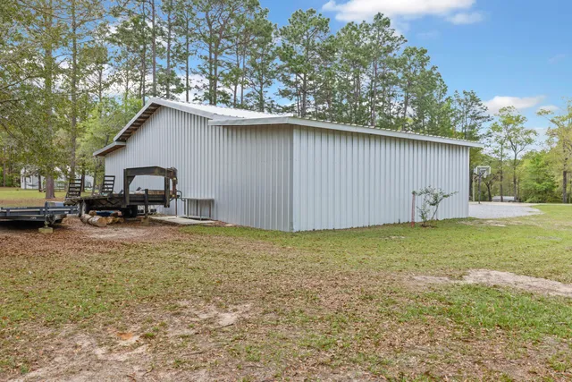 a view of a house with a yard and garage
