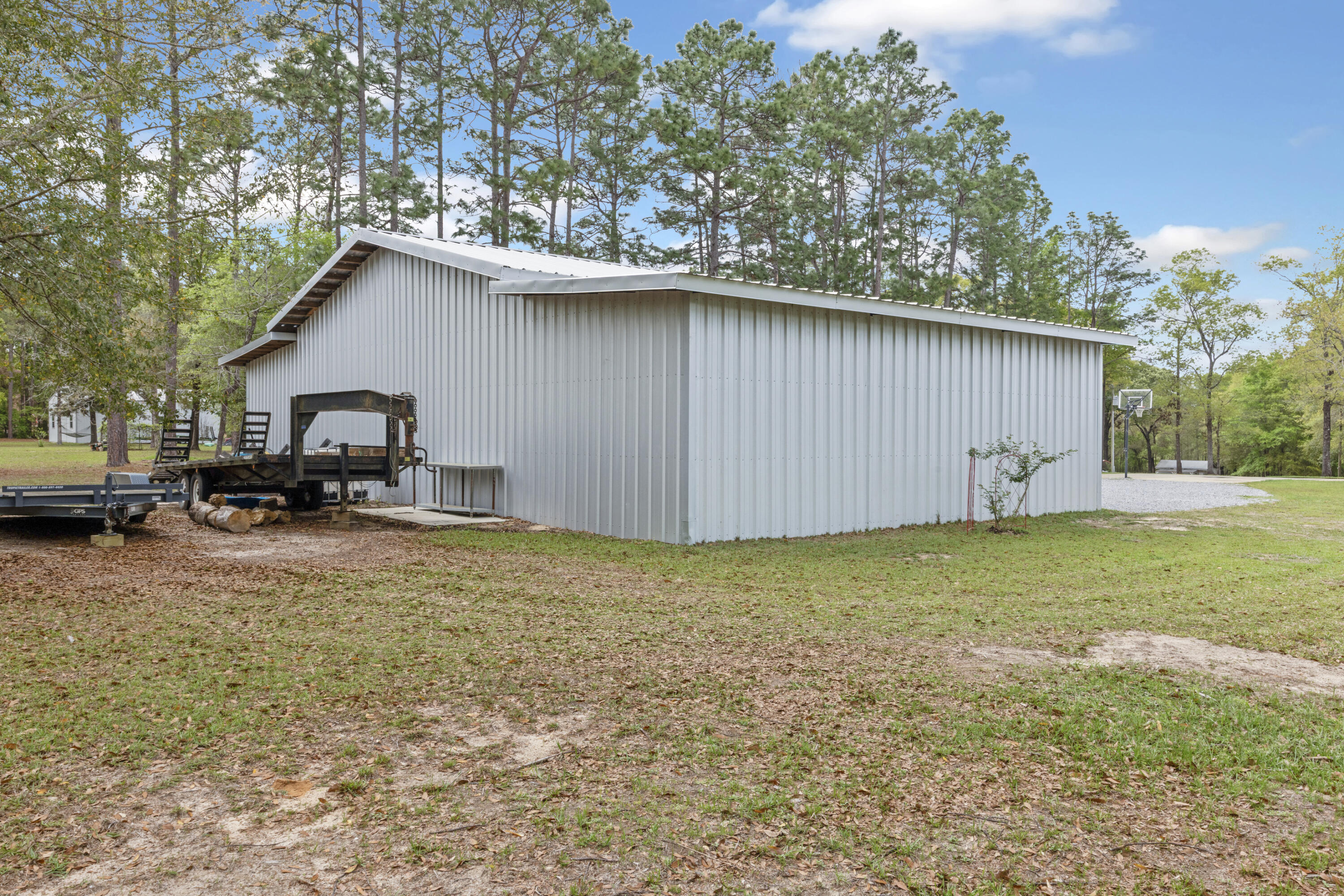 1582 Greenwood Road Baker, FL 32531 - Photo 40 of 52 a backyard of a house with table and chairs