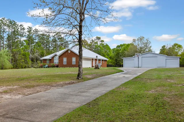 a front view of house with yard and green space