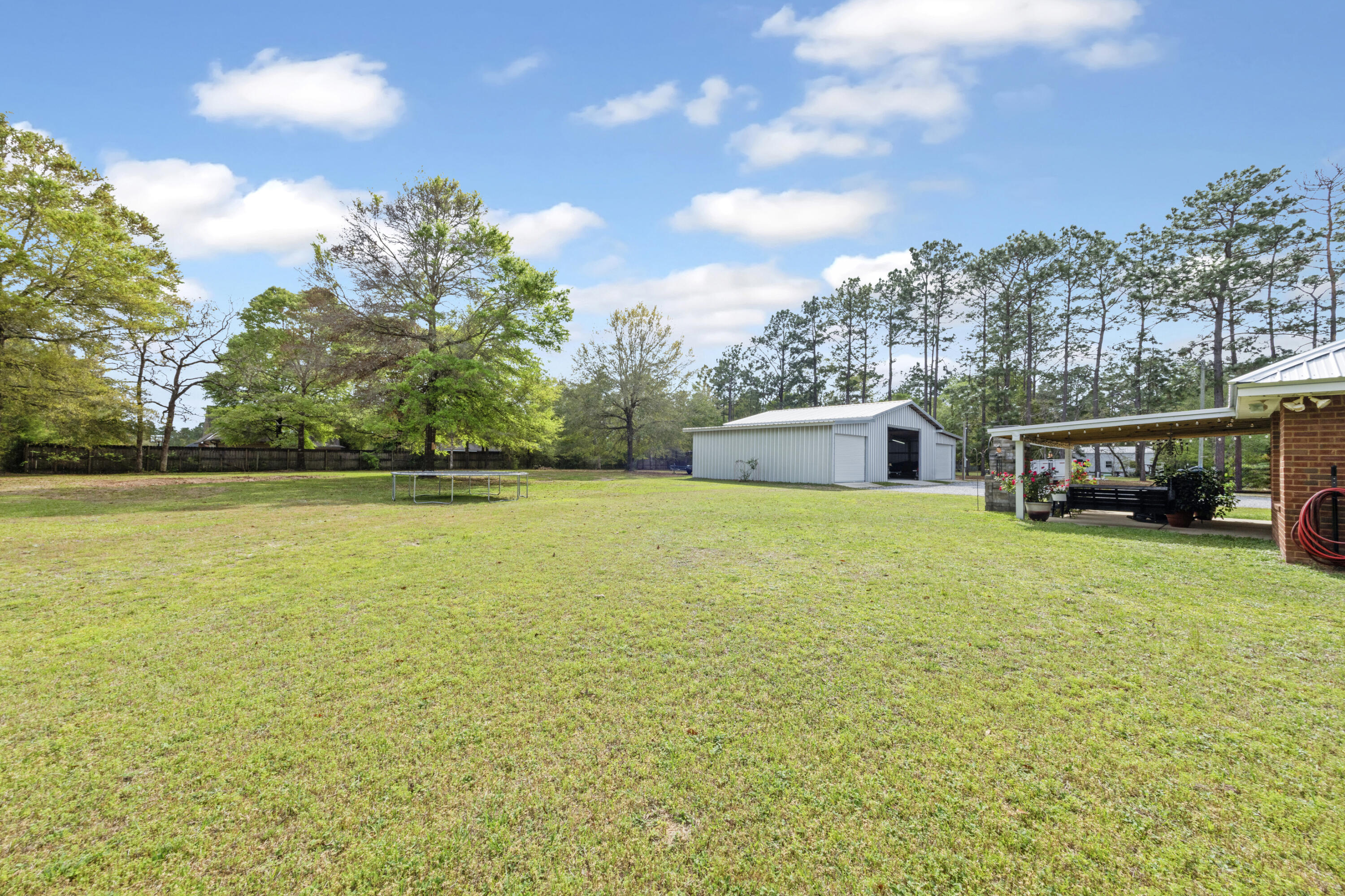 1582 Greenwood Road Baker, FL 32531 - Photo 42 of 52 a house view with swimming pool and trees in the background