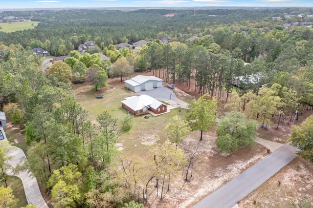 an aerial view of a house with a yard