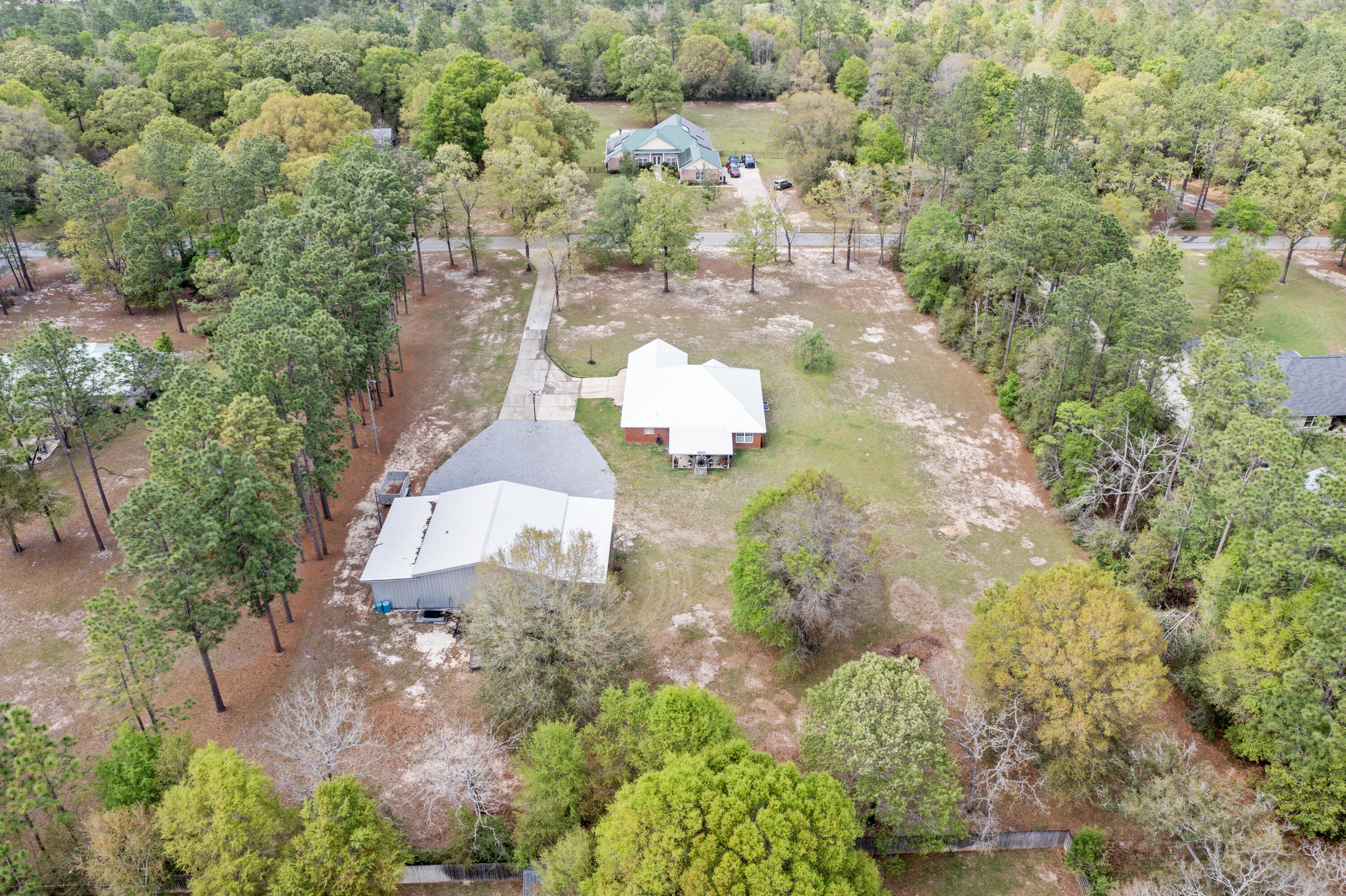 1582 Greenwood Road Baker, FL 32531 - Photo 47 of 52 an aerial view of a house with a yard and covered with trees