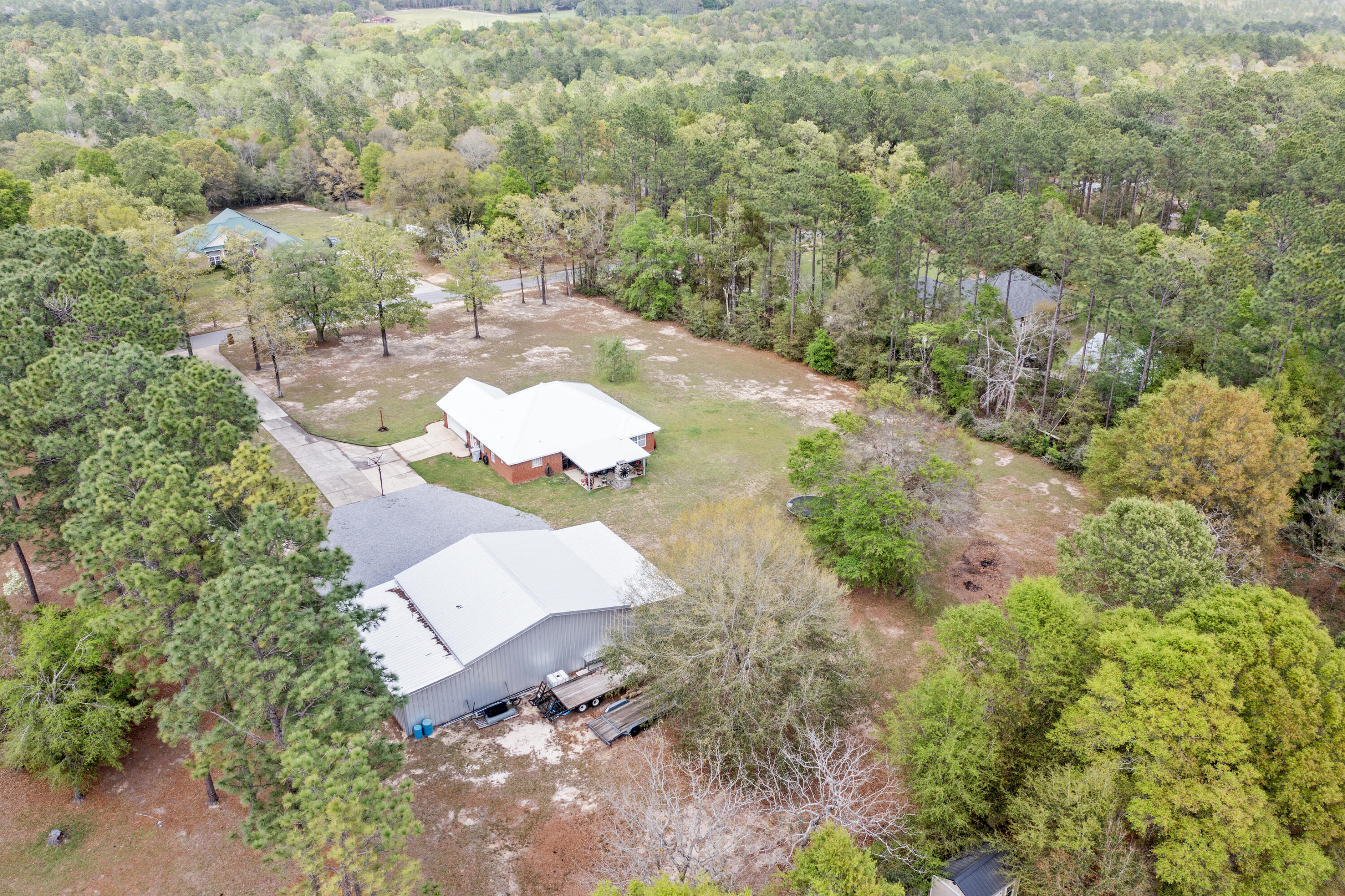 1582 Greenwood Road Baker, FL 32531 - Photo 48 of 52 an aerial view of a house with a yard and trees