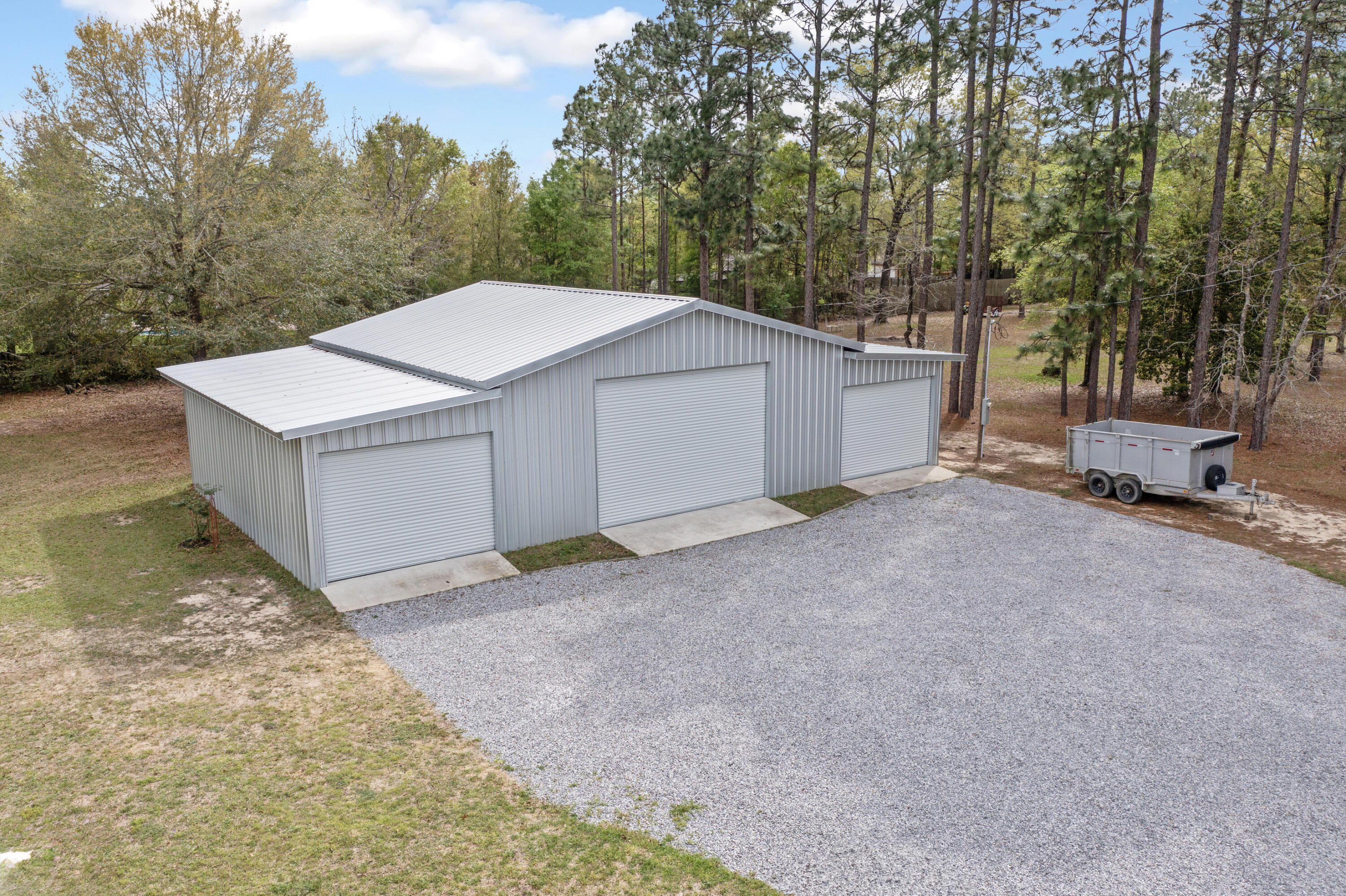 1582 Greenwood Road Baker, FL 32531 - Photo 50 of 52 a view of a house with backyard and trees