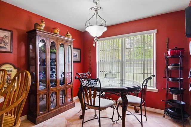 a dining hall with a dining table and chairs