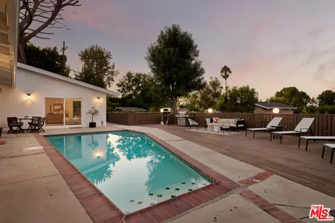 a view of a swimming pool with chairs